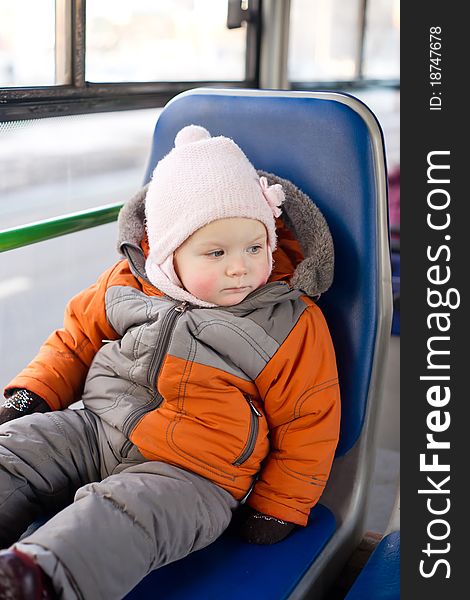 Adorable baby riding in city bus on seat place