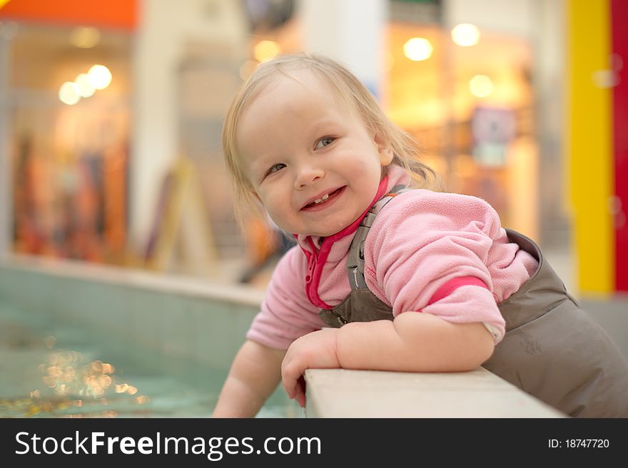 Adorable Girl Playing In A Public Fountain