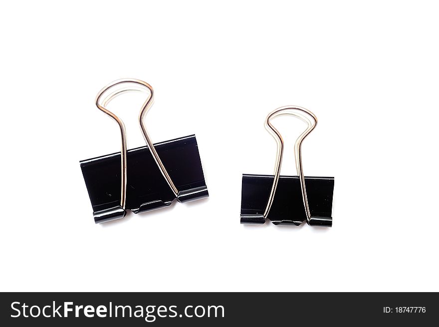 An image of black paper clips on white
