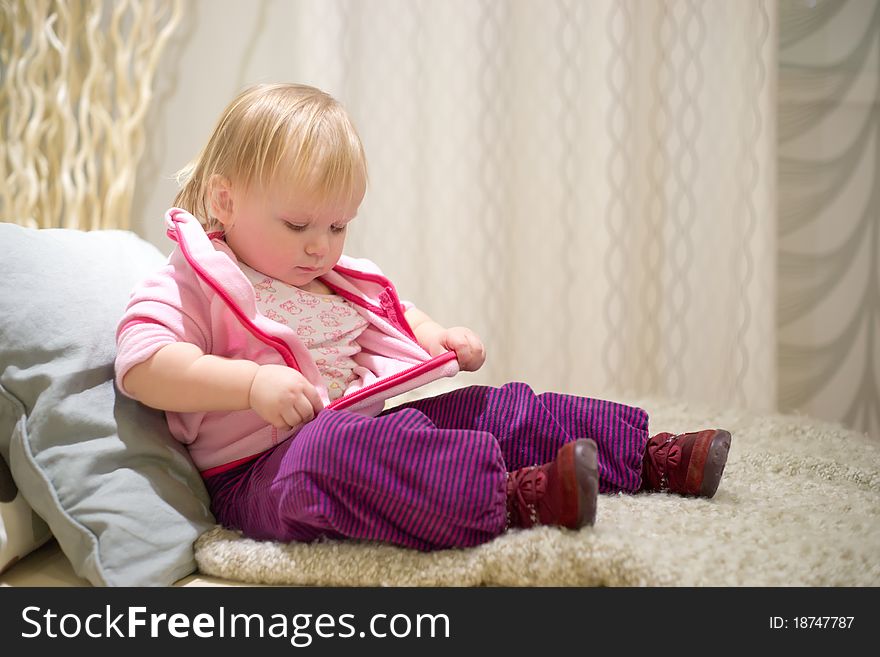 Young adorable baby preparing to sleep on sofa in bedroom