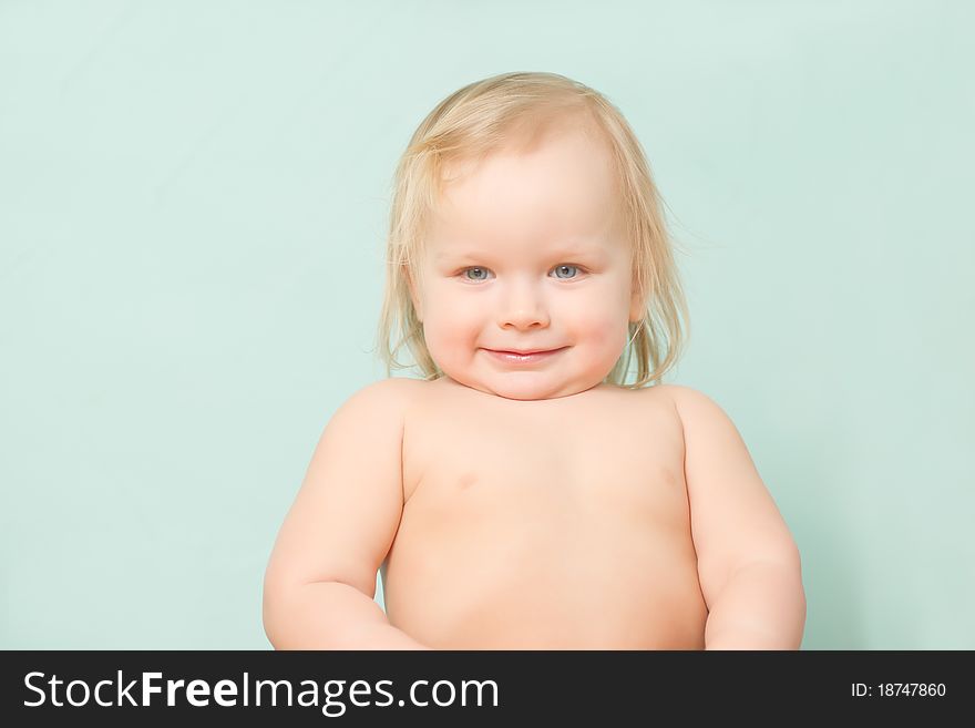 Adorable happy baby stay in kitchen after lunch