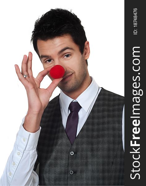 Young man magican making clown nose isolated on white