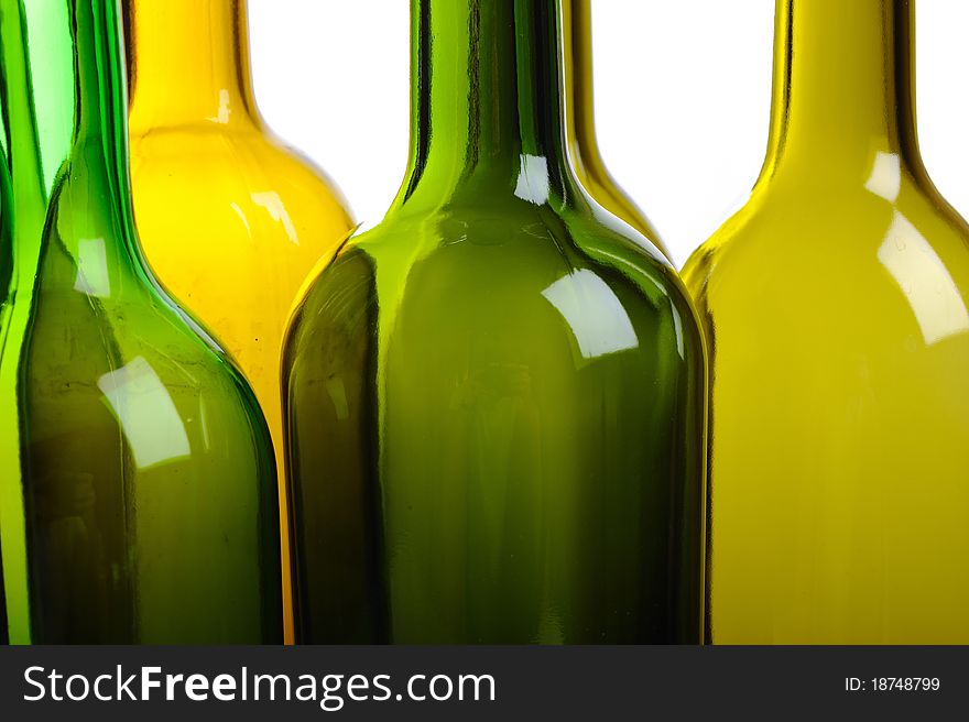 Many empty green wine bottles isolated on white background