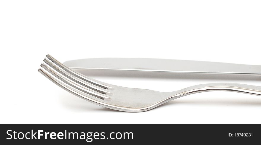 Close up of a knife and fork on white background