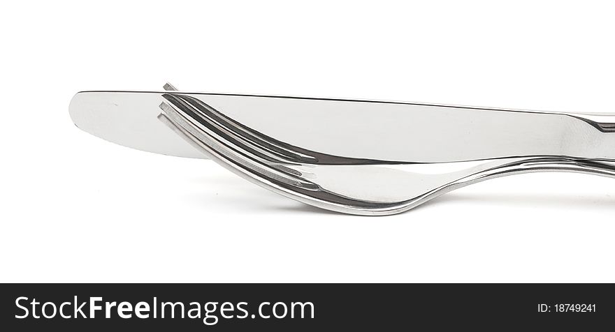 Close up of a knife and fork on white background