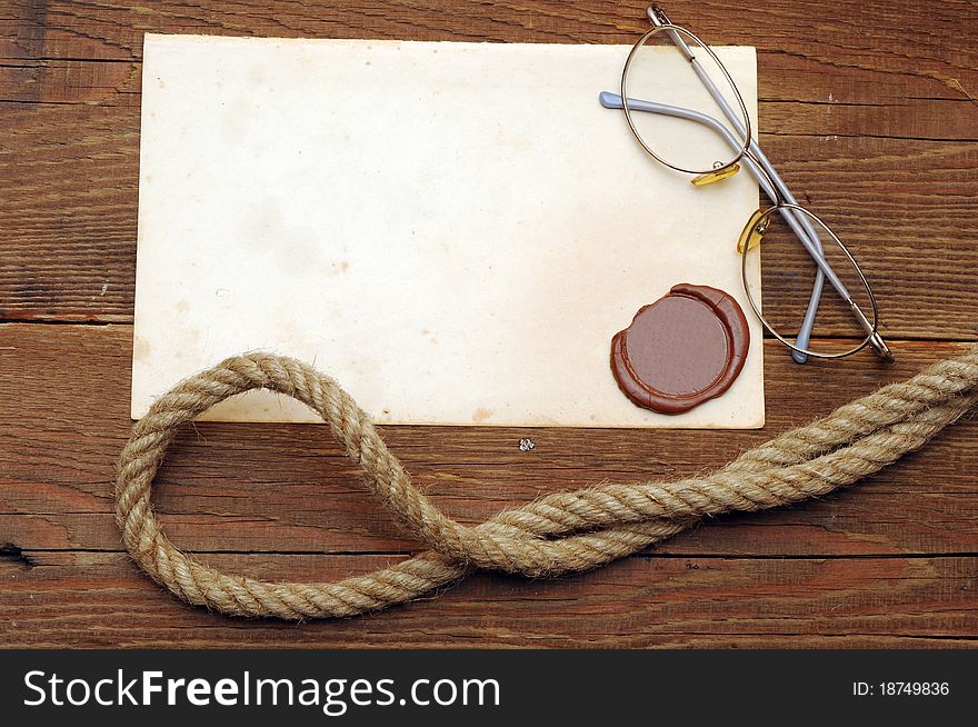 Old paper with a wax seal on a wood background