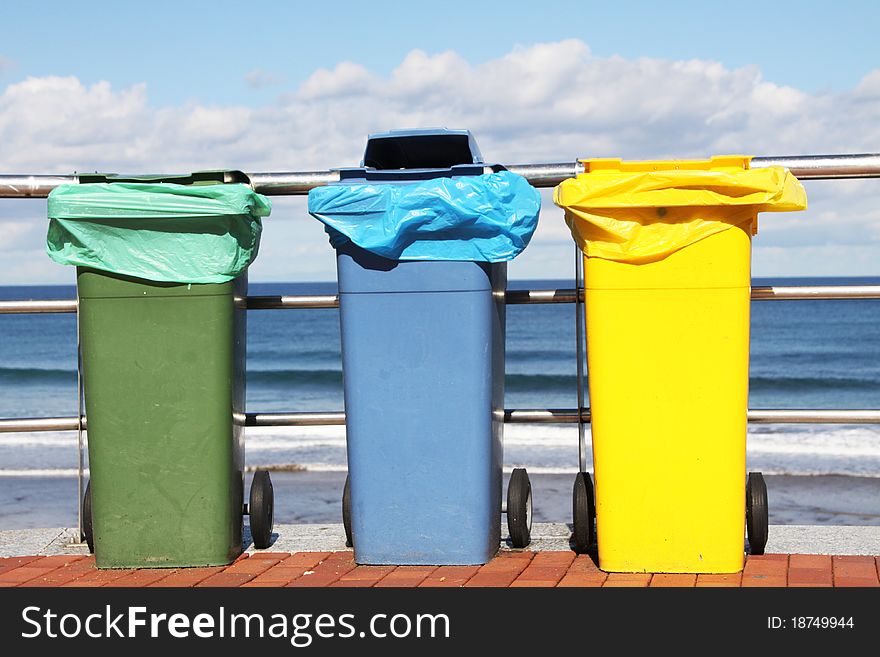 Recycling bins in front the sea