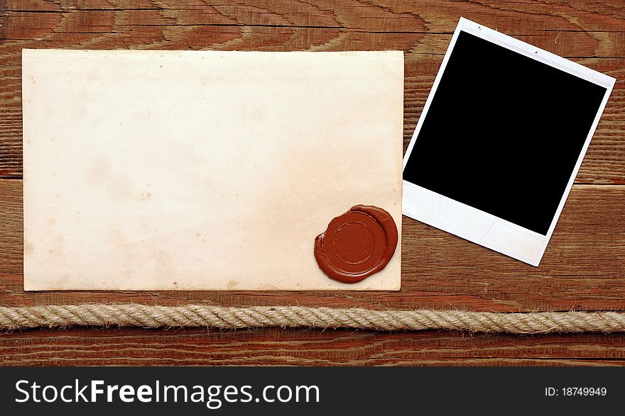 Old paper with a wax seal on a wood background