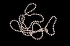 Pearl Beads On A Black Stock Photo