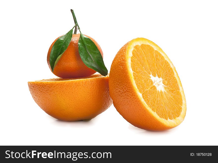 Two half of orange and a tangerine with top isolated on a white background. Two half of orange and a tangerine with top isolated on a white background