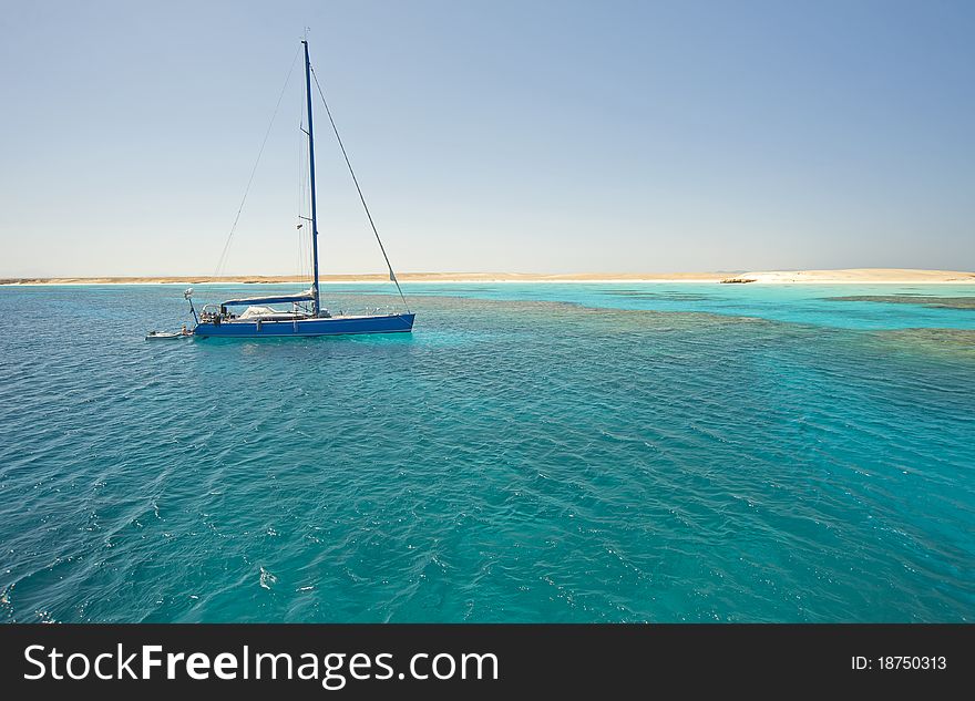 Large sailing yacht in a tropical lagoon