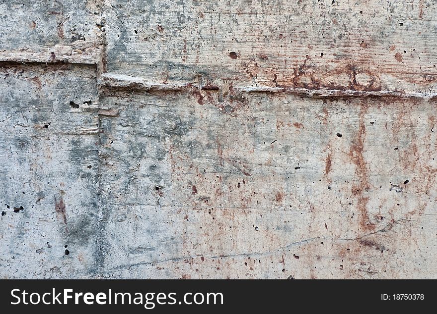 Raw texture of concrete wall with reddish blots