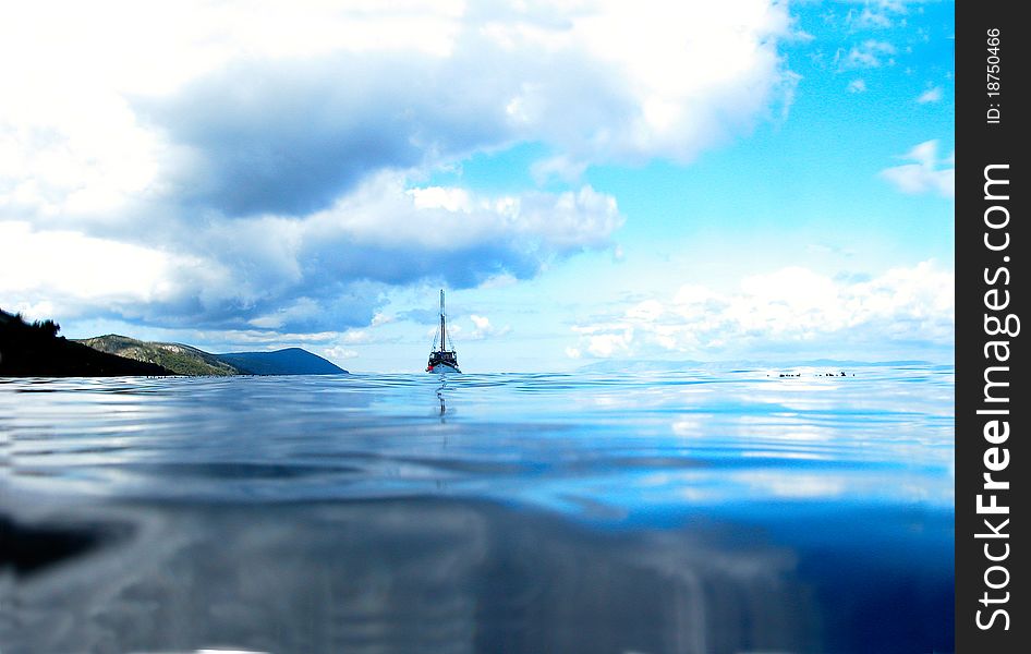 Ship Floating on Lake Under Sunny Blue Sky. Ship Floating on Lake Under Sunny Blue Sky