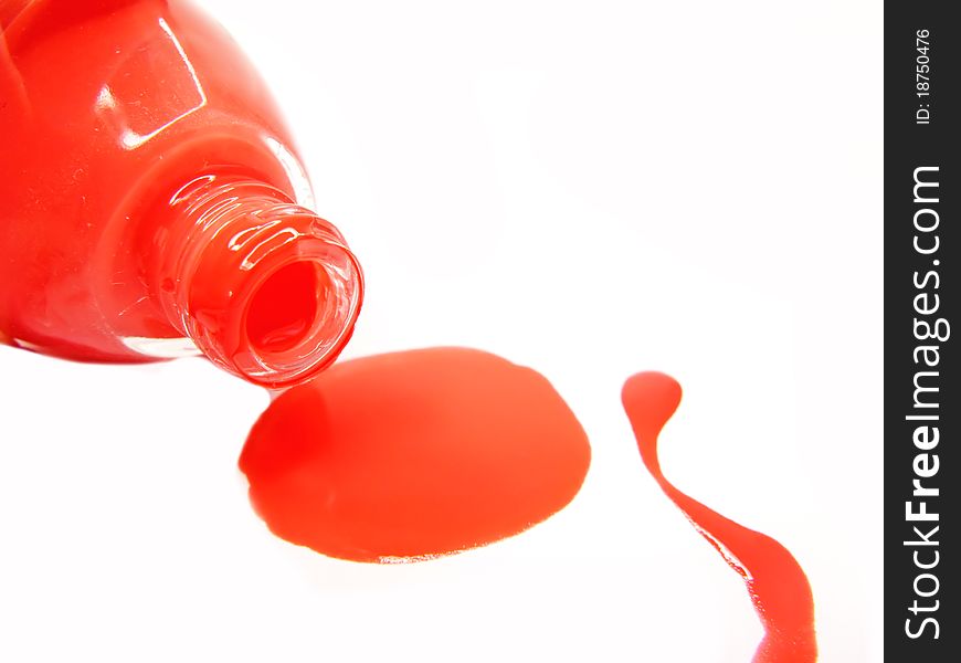 Red pouring nail polisher isolated on white