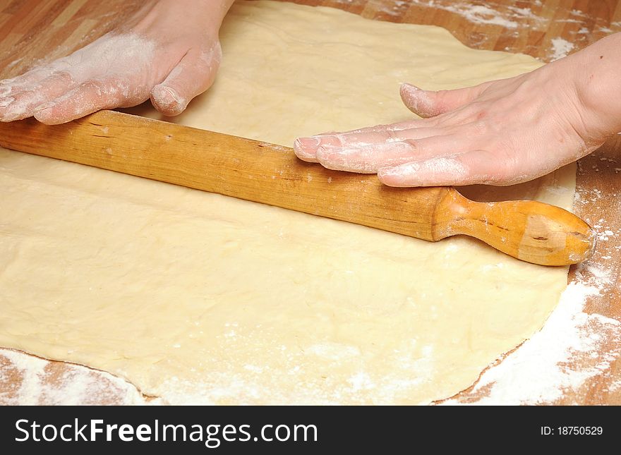 Rolling dough on wooden table