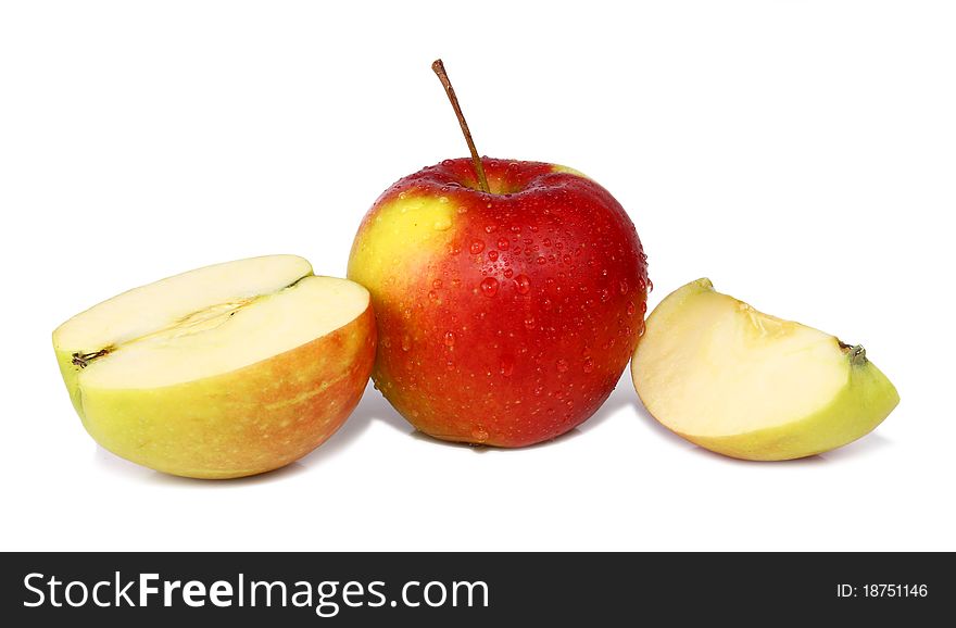 Cut apple is in drops isolated on white background