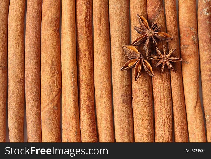 Three star anises layingon cinnamon quills. Close-up. Three star anises layingon cinnamon quills. Close-up