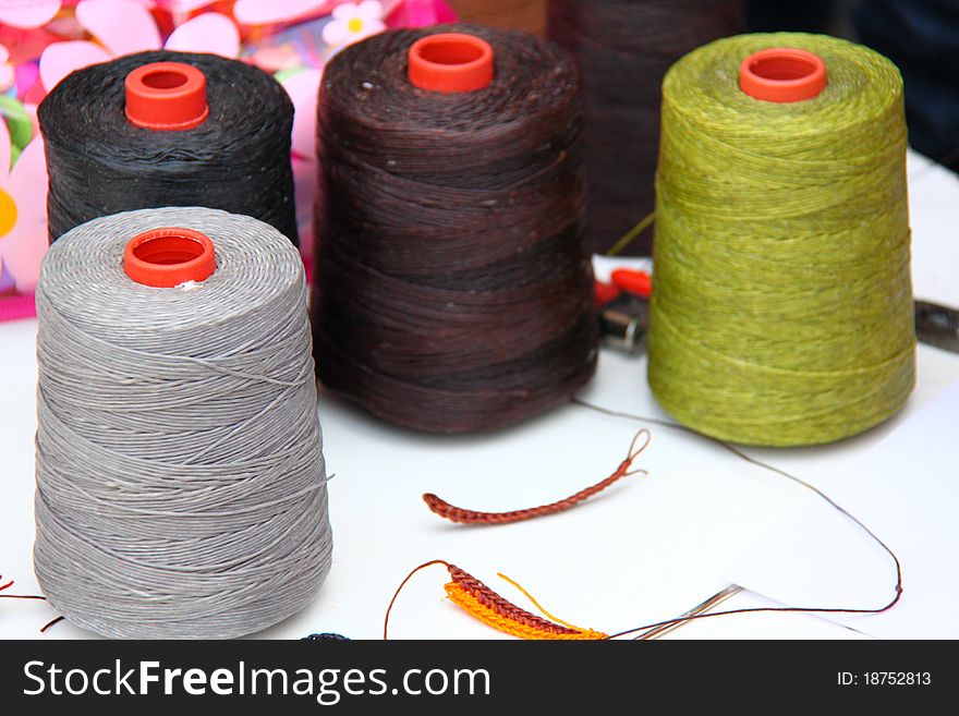 Stock image spool of thread  on a background