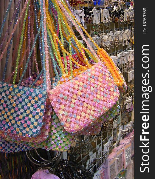Colorful beaded bags on a stand at the market. Colorful beaded bags on a stand at the market