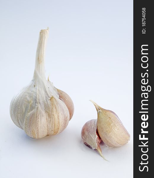 Head and the cloves of garlic isolated on white