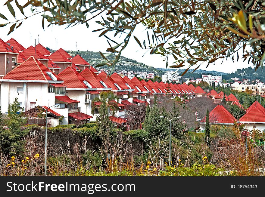 Street of houses with red tile roofs cusp. Street of houses with red tile roofs cusp