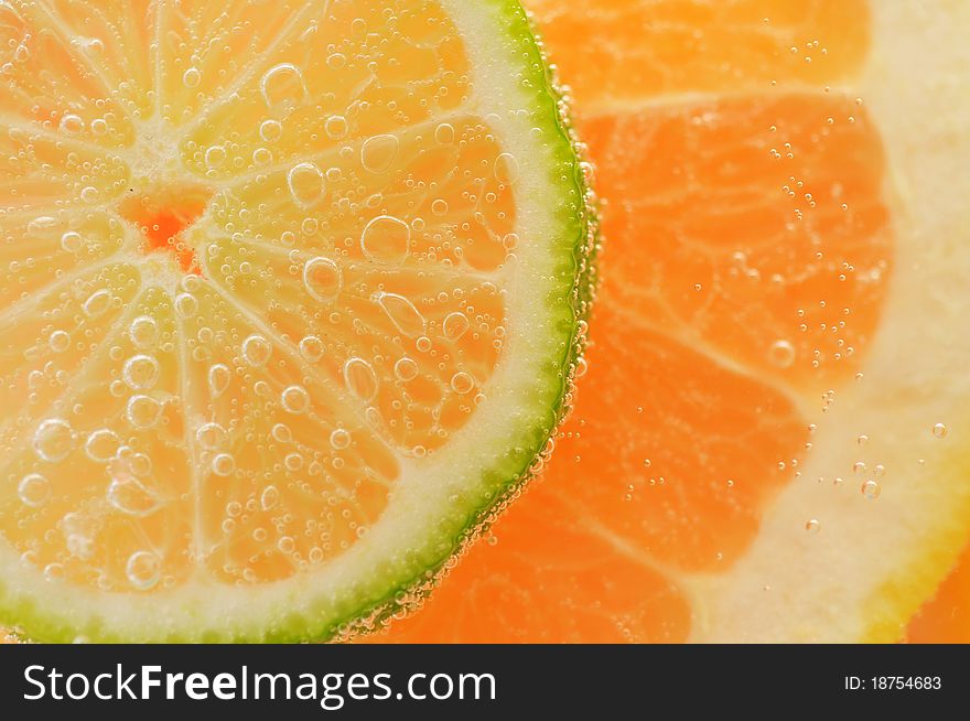 Sliced grapefruit with lime in mineral water. Sliced grapefruit with lime in mineral water
