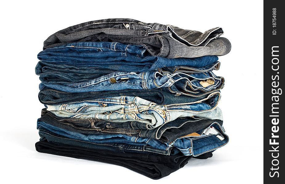 Stack of various jeans isolated on white