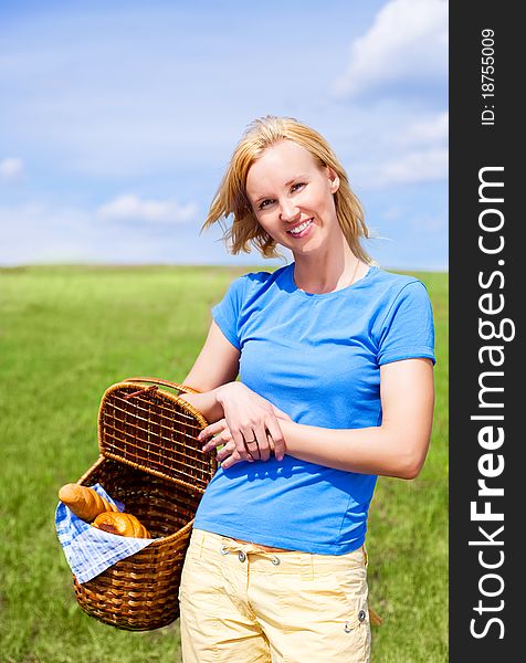 Happy young blond woman having a picnic outdoor on a summer day. Happy young blond woman having a picnic outdoor on a summer day