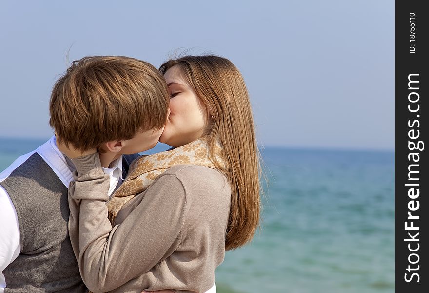 Couple kissing at spring sea. Outdoor shot.