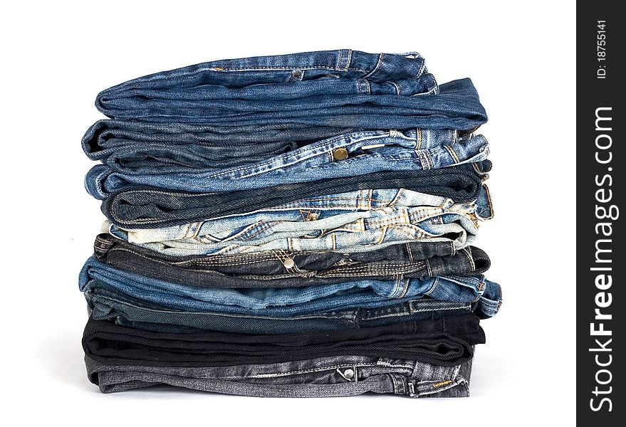 Stack of various jeans isolated on white