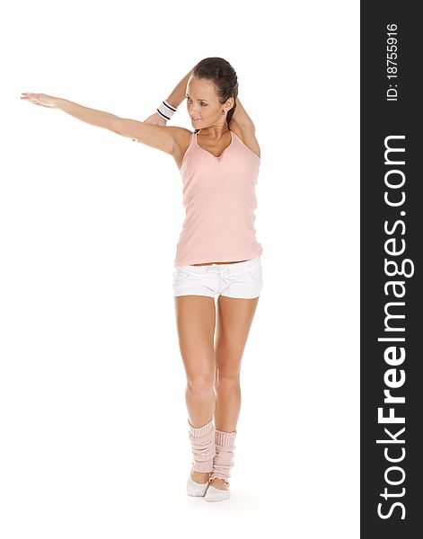 Girl athlete stretching hands and posing on white