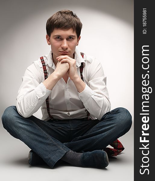 Pensive man sitting on floor