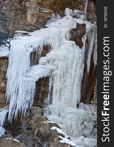 Frost waterfall on rock in Alps mountains