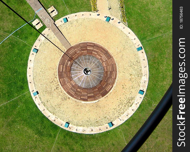 Circle-like balloon starting and landing zone, embedded in green meadows landscape.