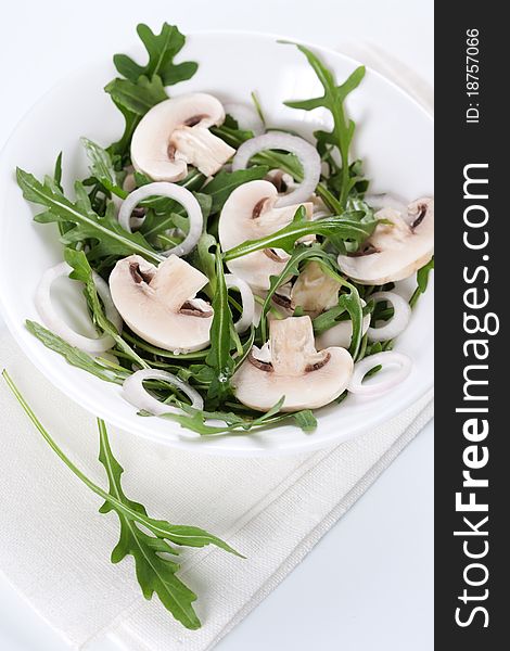 Fresh salad with rucola, mushrooms and onion in bowl. Fresh salad with rucola, mushrooms and onion in bowl