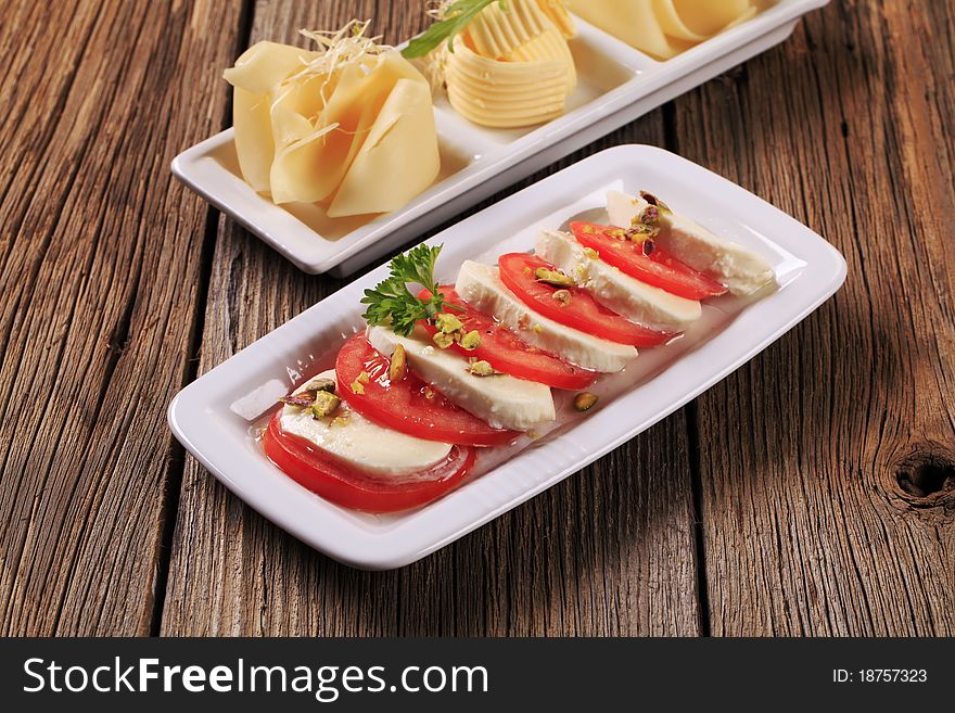 Caprese salad and Swiss cheese with butter. Caprese salad and Swiss cheese with butter