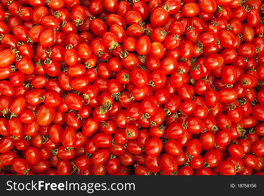 Many cherry tomatoes bathed in the sunlight on the local farmerâ€™s market. Many cherry tomatoes bathed in the sunlight on the local farmerâ€™s market.