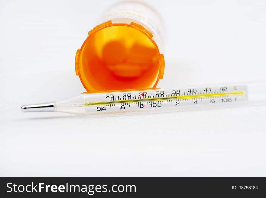 A thermometer and drugs on a white background. A thermometer and drugs on a white background