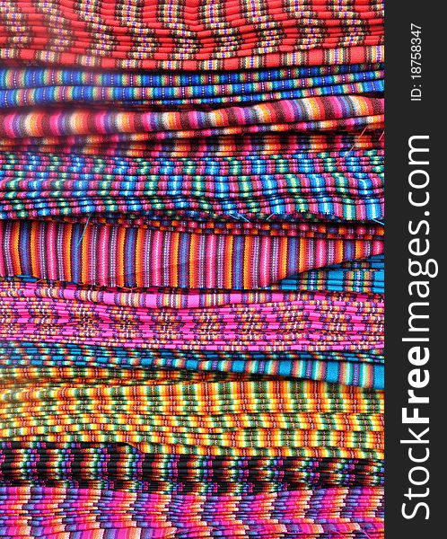 Traditional patterned fabric for sale in an Ecuadorian market. Traditional patterned fabric for sale in an Ecuadorian market.