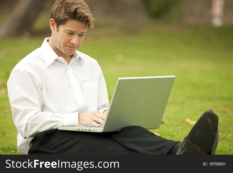 Man looking at his laptop outside. Man looking at his laptop outside