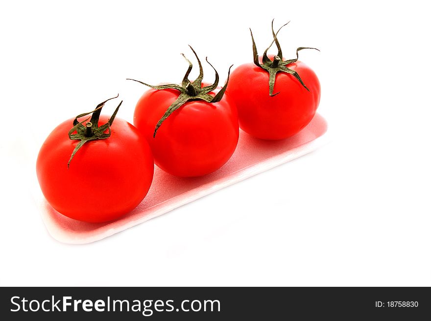 Three red tomatoes on a substrate. Three red tomatoes on a substrate