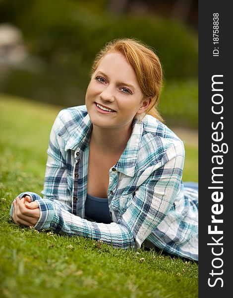 Pretty young woman sitting outside