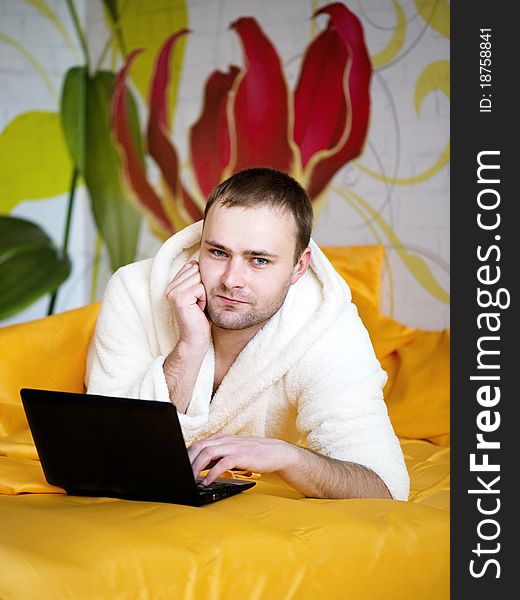 Handsome Man Lying In Bed With Laptop