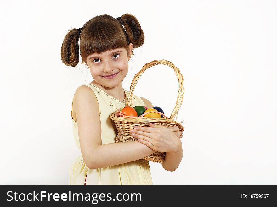 Girl keeping the basket with Easter painted eggs. Girl keeping the basket with Easter painted eggs
