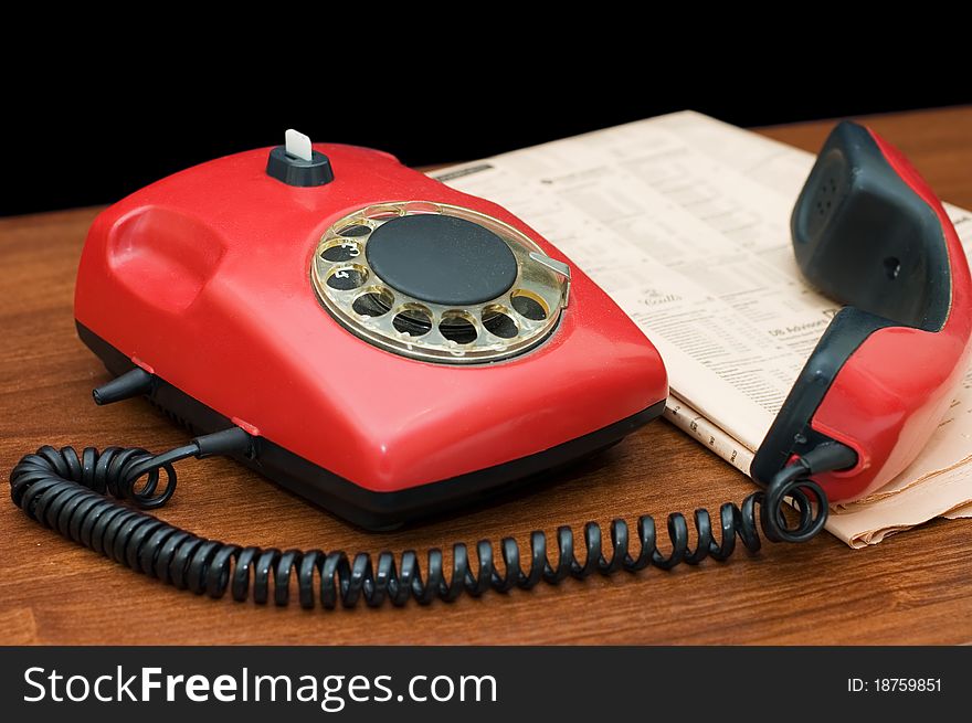 Red Phone On A Wooden Table