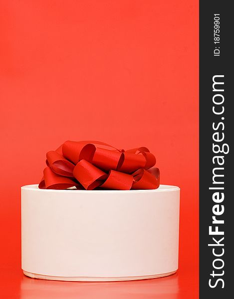 Box with a gift on the red background