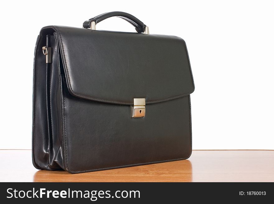Fashionable leather briefcase on a table still life