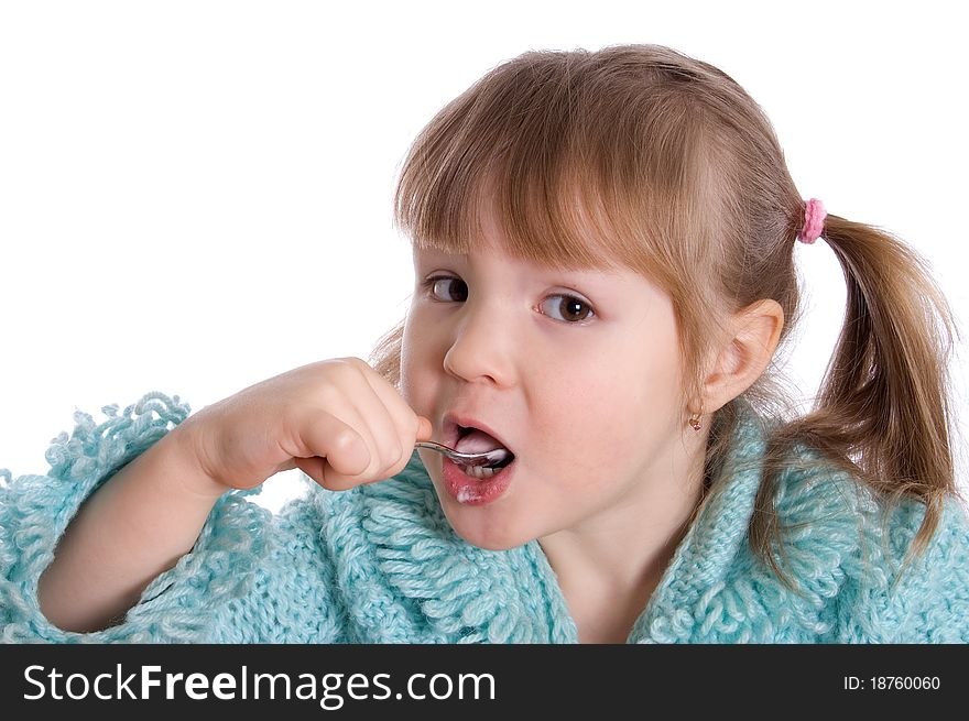 The little girl eats yoghurt on white