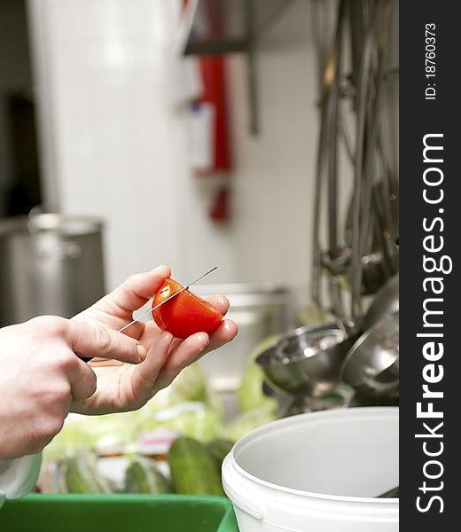 Preparing tomato for salad in a commercial kitchen