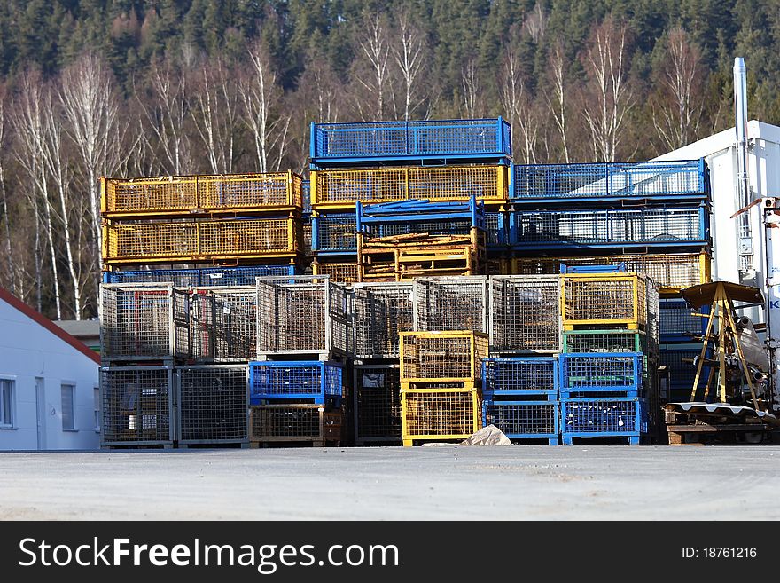 A pile of blue and yellow transport boxes